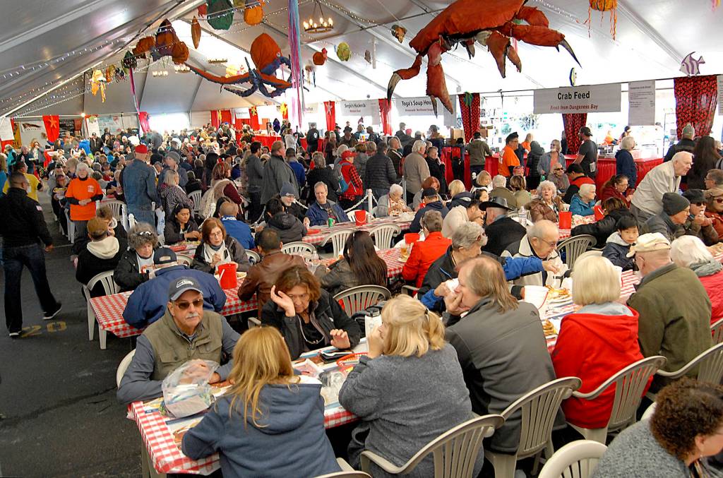Crab festival attendees line up for crab dinners while others dine on a variety of sea food available in the main tent in 2019. File photo by Keith Thorpe/Olympic Peninsula News Group
