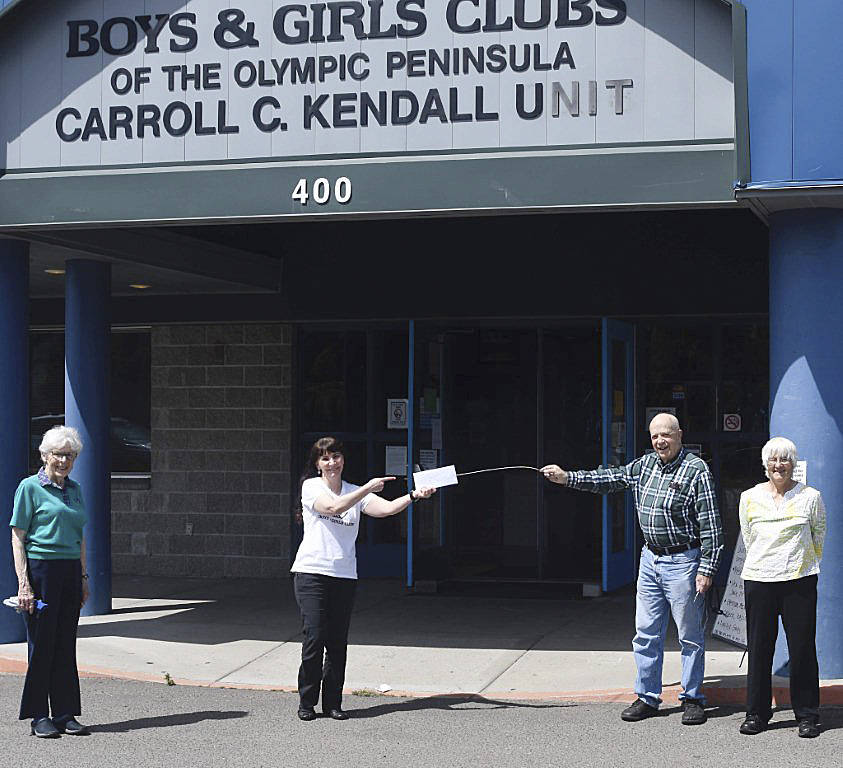 Rotarians Lang and Mary Hadley, right, along with Barbara Hughes, donate funds to the Boys & Girls Club  represented here by executive director Mary Budke  for the B&G Clubs Grab n Go summer youth meal program. Photo by Doug Schwarz