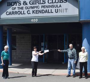 Rotarians Lang and Mary Hadley, right, along with Barbara Hughes, donate funds to the Boys & Girls Club  represented here by executive director Mary Budke  for the B&G Clubs Grab n Go summer youth meal program. Photo by Doug Schwarz
