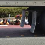Lyndsai Seator of Sequim watches as a semi-truck circles the River Road roundabout on June 4 while she and other demonstrators lay down in support of the Black Lives Matter movement and to recognize the death of George Floyd. Sequim Gazette photo by Matthew Nash