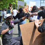 Deej Jones of Sequim fist bumps 
demonstrators as they march along Washington Street in support of the Black Lives Matter movement, and against police brutality and racism. Sequim Gazette photo by Matthew Nash