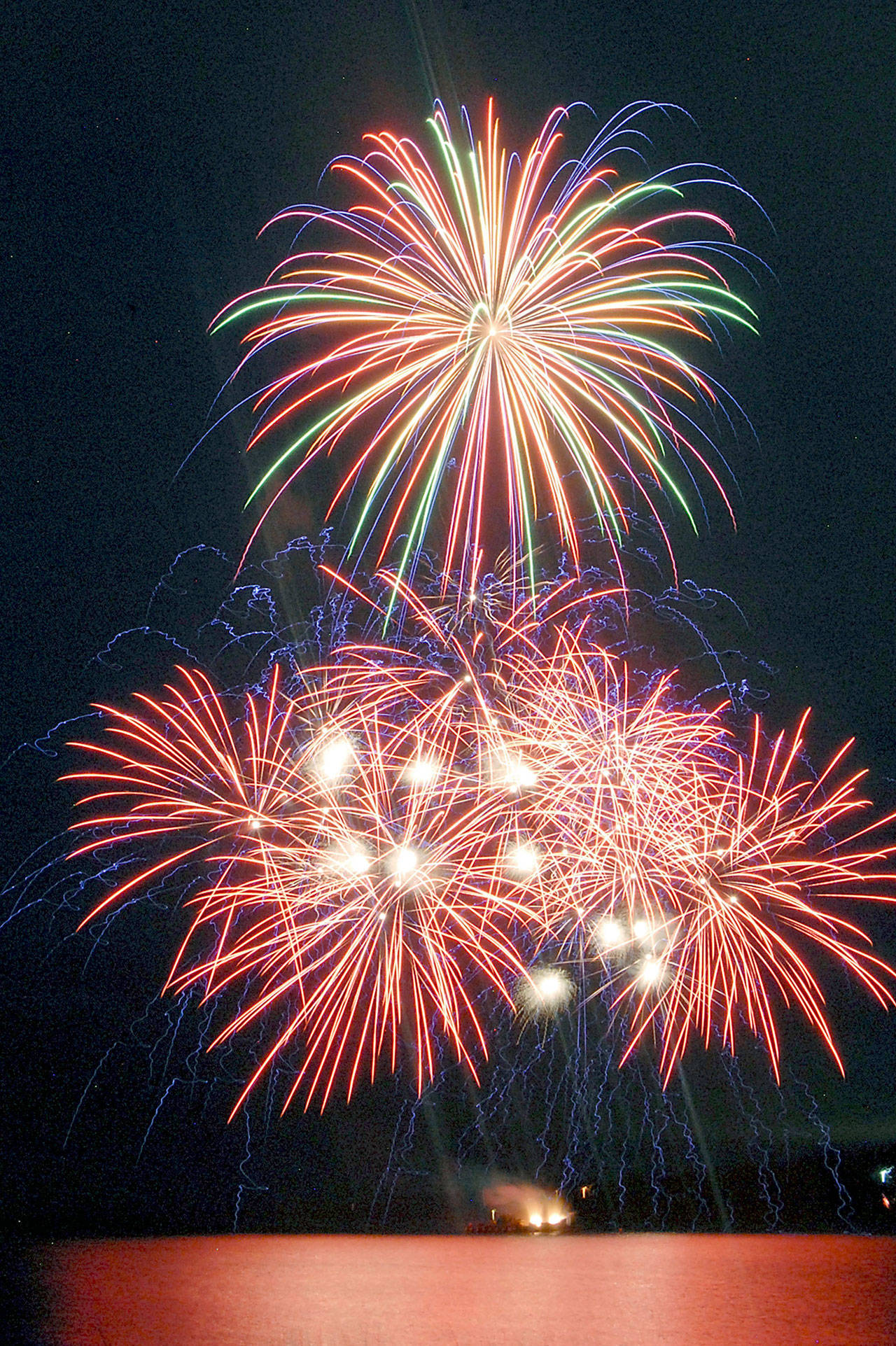 Bursts of fireworks light up the sky over Port Angeles Harbor during the 2019 Independence Day display. Photo by Keith Thorpe/Olympic Peninsula News Group