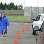 Graduate-to-be Lily Engeset waves to family and friends during the Pomp and Circumstance march on June 12. Sequim Gazette photo by Matthew Nash