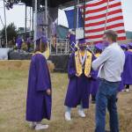 Sequim High School graduates-to-be (left) Wren Fierro Burdick and Kyle Desumma talk with teacher Michael Lippert at Fridays SHS commencement ceremony. Sequim Gazette photo by Michael Dashiell
