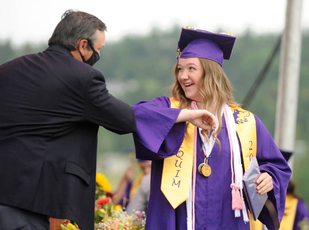 Payton Sturm gets an elbow bump from Sequim High School principal Shawn Langston at Fridays SHS commencement ceremony. Sequim Gazette photo by Michael Dashiell