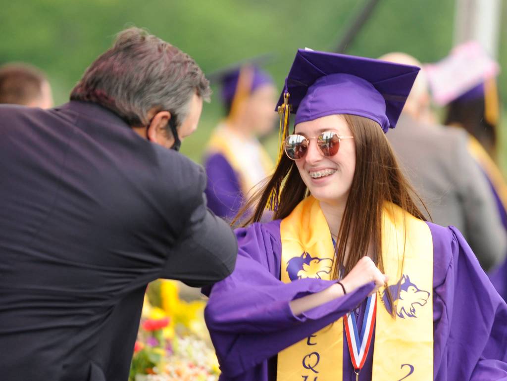 Abbee Jagger gets an elbow bump from Sequim High School principal Shawn Langston at Fridays SHS commencement ceremony. Sequim Gazette photo by Michael Dashiell