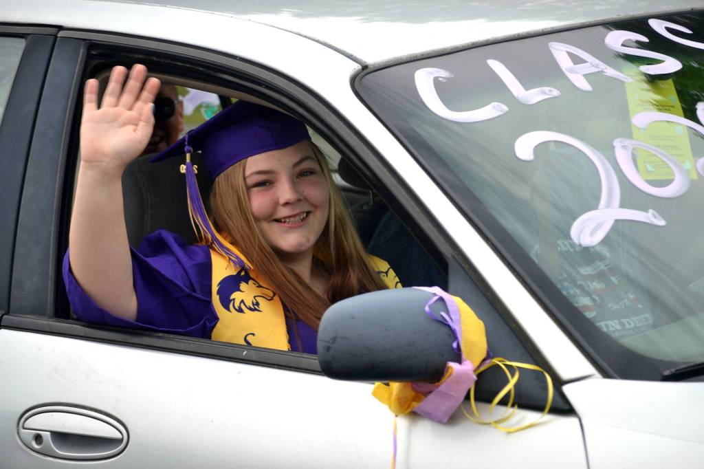 Victoria Lelle waves during a parade to the Sequim High Schools graduation on June 19. Sequim Gazette photo by Matthew Nash