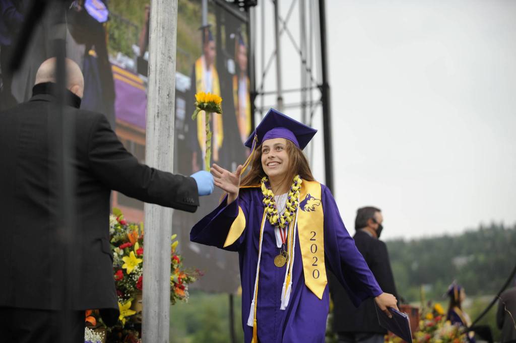Graduating senior Jessica Dietzman gets a flower from Sequim school superintendent Dr. Rob Clark at Fridays SHS commencement ceremony. Sequim Gazette photo by Michael Dashiell