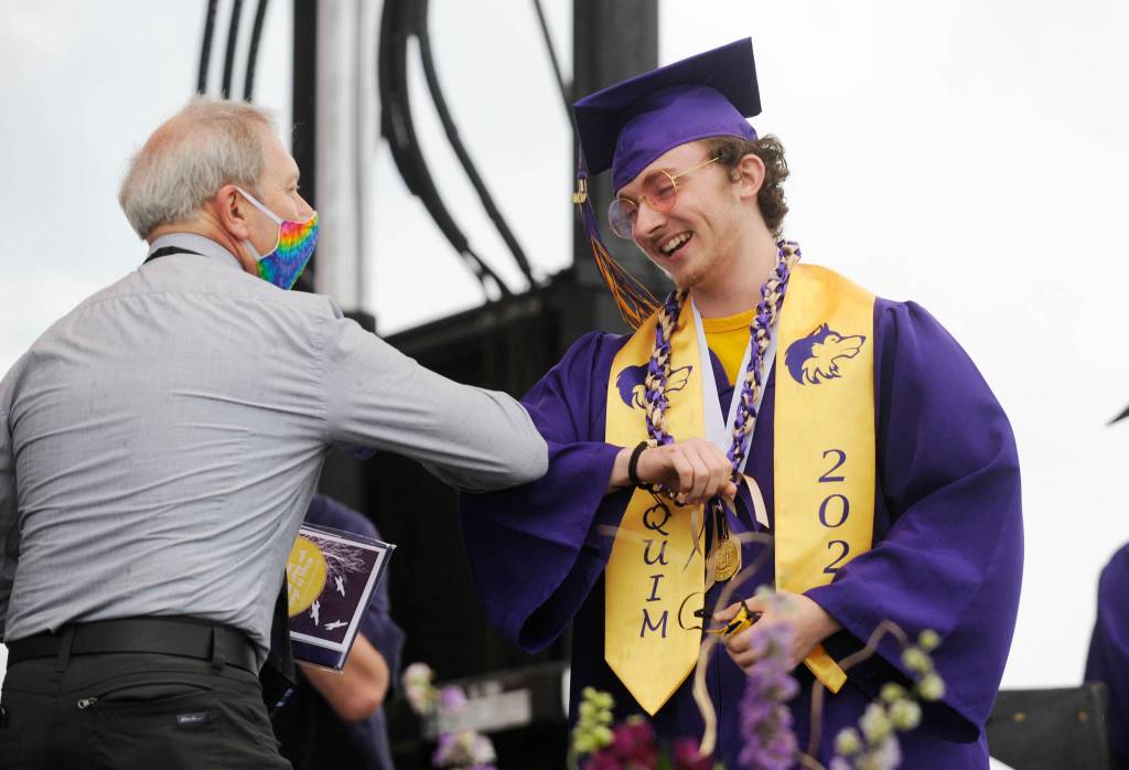 Kyle Desumma gets an elbow bump from Sequim High School principal Shawn Langston at Fridays SHS commencement ceremony. Sequim Gazette photo by Michael Dashiell