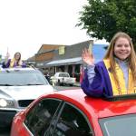 Sequim High graduates-to-be Morgan Cariou, right, and Lydia Stidham wave to well-wishers along Washington Street just prior to Sequim High Schools graduation ceremony on June 19. Sequim Gazette photo by Matthew Nash
