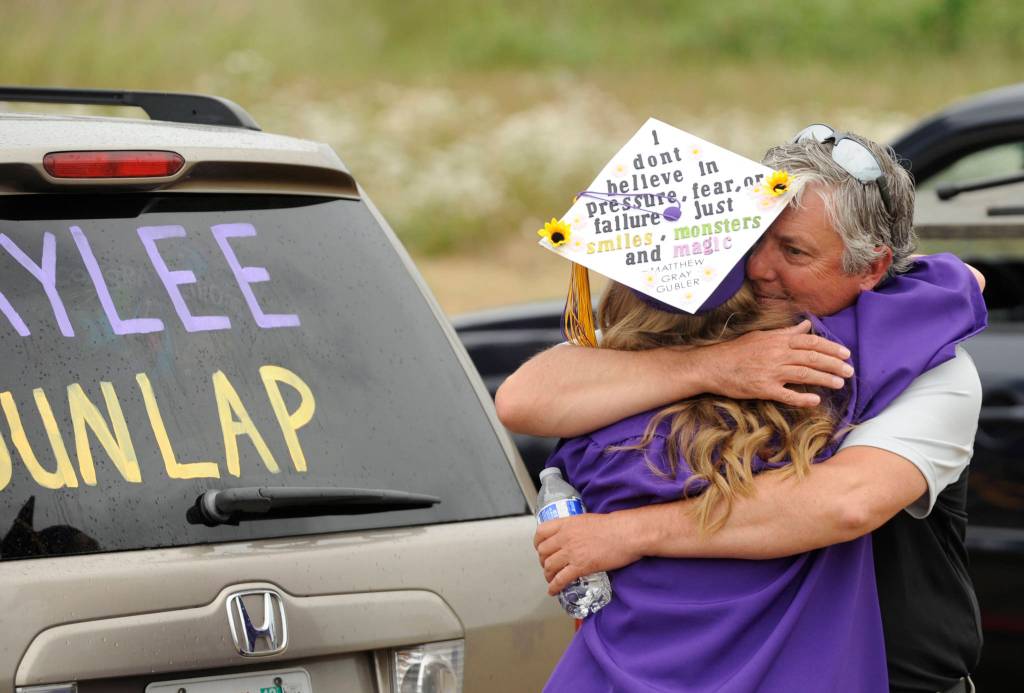 New Sequim High graduate Kaylee Dunlap get a hug from dad Tracy following the SHS commencement ceremony on June 19. Sequim Gazette photo by Michael Dashiell