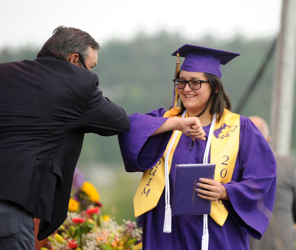 Tigerlilly McMeen gets an elbow bump from Sequim High School principal Shawn Langston at Fridays SHS commencement ceremony. Sequim Gazette photo by Michael Dashiell