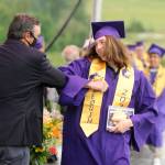 After receiving his diploma, Navy Thomas-Brenske gets an elbow bump from Sequim High School principal Shawn Langston at Fridays SHS commencement ceremony. Sequim Gazette photo by Michael Dashiell