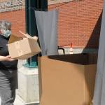 Mary Givins, a student librarian at the Port Angeles Public Library, takes part in a trial run to initiate curbside drop-off of returning books in the drive-in front of the library on June 16. The four North Olympic Library System libraries began curbside returns on June 17. Photo by Keith Thorpe/Olympic Peninsula News Group