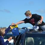Outgoing fifth grader Trenton Hopson accepts a gift bag from his Helen Haller Elementary teacher Mary Himley on June 17 during a drive-thru graduation ceremony. Sequim Gazette photo by Matthew Nash