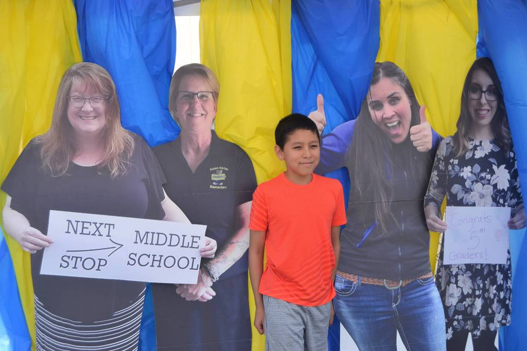 Yael Acosta stands with his fifth grade teachers, from left, Saxon Holt, Mary Himley, Meredith Vincent, and Brittney Rothwell during a special drive-thru fifth grade graduation at Helen Haller Elementary. Sequim Gazette photo by Matthew Nash