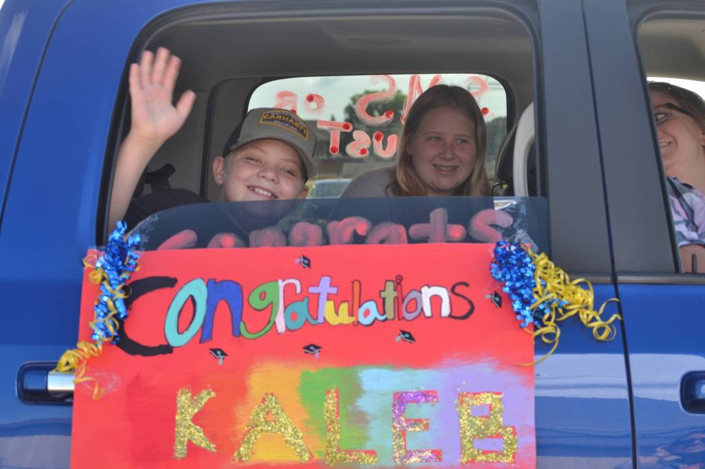 Kaleb Delph waves goodbye as he participates in Helen Haller Elementarys drive-thru graduation for its fifth graders on June 17. Sequim Gazette photo by Matthew Nash