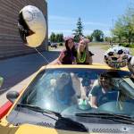 Sequim Middle School graduates Darian Johnson, left, and Susannah Sharp celebrate at the schools eighth-grade drive-thru graduation on June 17. Photo by Allison Hastings