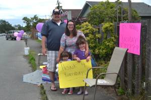 On June 20, the Hannam family sat outside their downtown Sequim home waving to cars in honor of Noras third birthday, See story on Page 3. Sequim Gazette photo by Matthew Nash