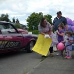 A driver drops off a plush duck for 3-year-old Nora Hannams honk and wave birthday party on June 20. Her mom Wynn, sister Ellie, and dad Jared held signs and waved as a family. Sequim Gazette photo by Matthew Nash