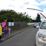 Grandma Keri Cook throws a pool noodle to daughter-in-law Wynn Hannam for granddaughter Noras birthday. The Hannam family, including Ellie, 5, and dad Jared, waved to drivers as theyd honk in celebration of the Sequim 3-year-olds birthday. Sequim Gazette photos by Matthew Nash