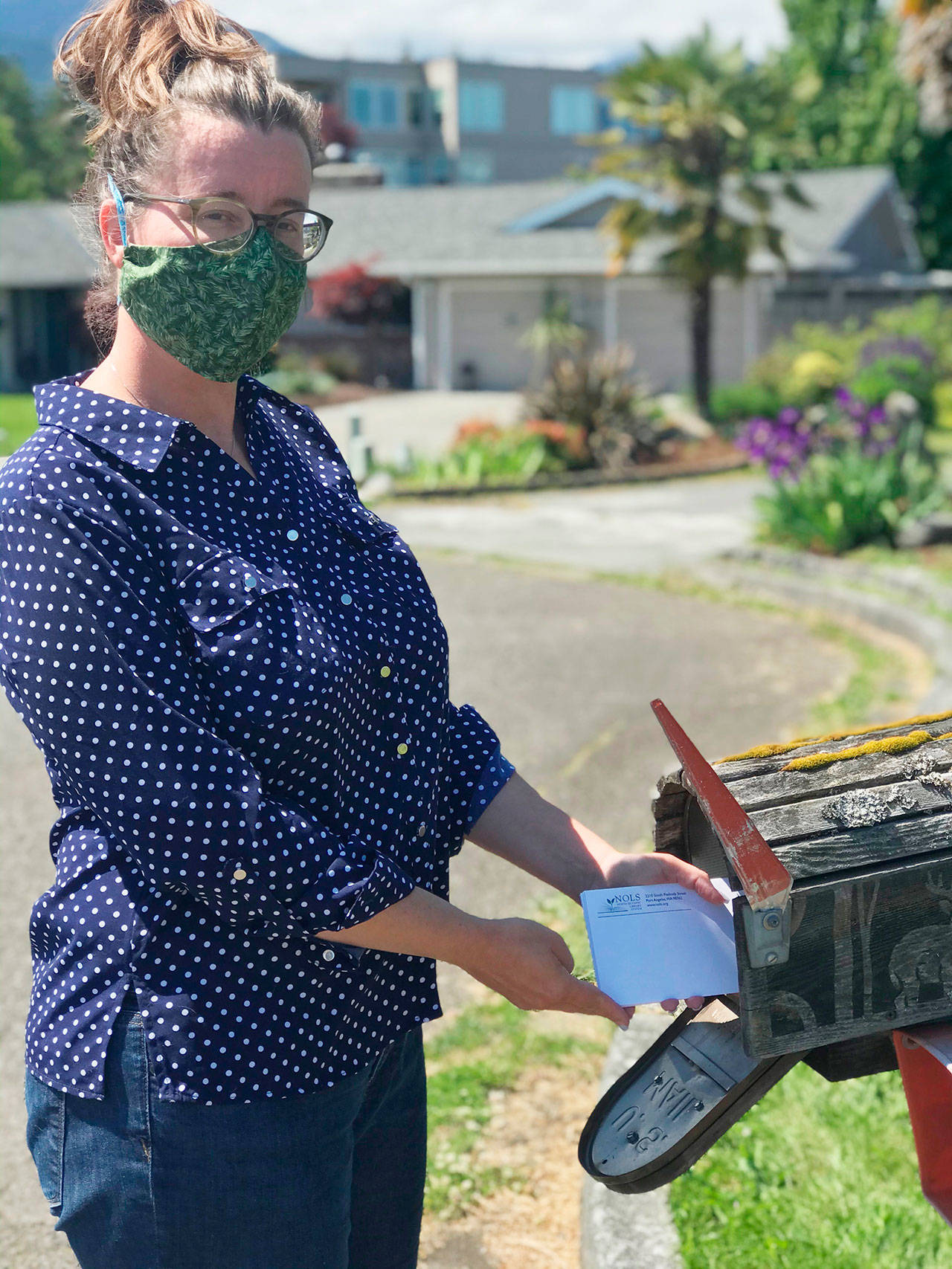 Dana Seevers, North Olympic Library System customer service specialist, sends packets from the NOLS Grows Seed Library to library users. Submitted photo