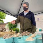 Logan Hart of Gunogan Fungus shows some of his medicinal and gourmet mushrooms at the Sequim Farmers & Artisans Market. Photo by Emma Jane Garcia