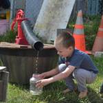 Wyatt Franklin, 5, fills a container at Sequims Little Explorers Early Learning Center last week as part of an outdoor preschool class. The centers owners split their preschool in two to allow for more social distancing. Sequim Gazette photo by Matthew Nash