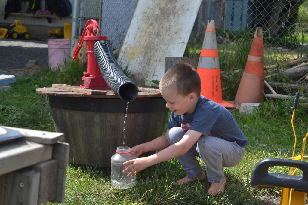 Wyatt Franklin, 5, fills a container at Sequims Little Explorers Early Learning Center last week as part of an outdoor preschool class. The centers owners split their preschool in two to allow for more social distancing. Sequim Gazette photo by Matthew Nash