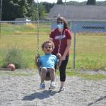 Sarah Schmedding pushes Harry Piper on the swings at Bibity Bobity last week. As some of the provisions at the center, parents must remain in the lobby, staff and childrens temperatures are taken, and social distancing is required between age groups. Sequim Gazette photo by Matthew Nash