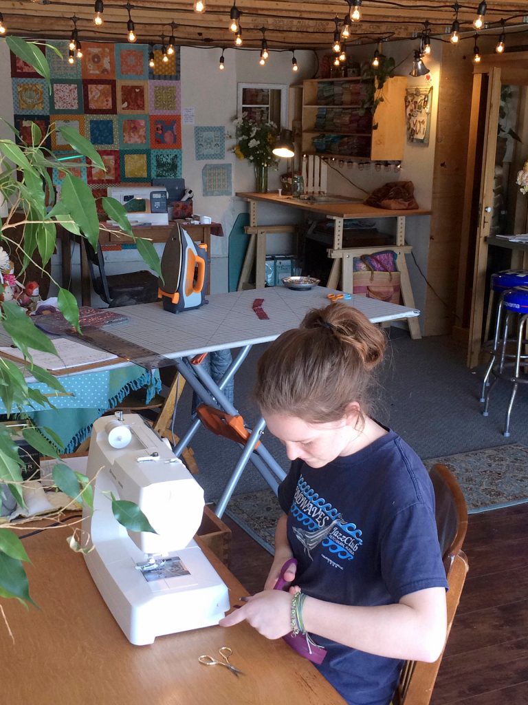 Ruby Romano, pictured here at work, sells her beadwork creations at the Sequim Farmers & Artisans Market. Submitted photo