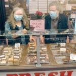 Northwest Fudge and Confections co-owners Lindi and Bob Lumens wear their masks behind the fudge counter in their downtown Port Angeles candy store. Photo by Keith Thorpe/Olympic Peninsula News Group