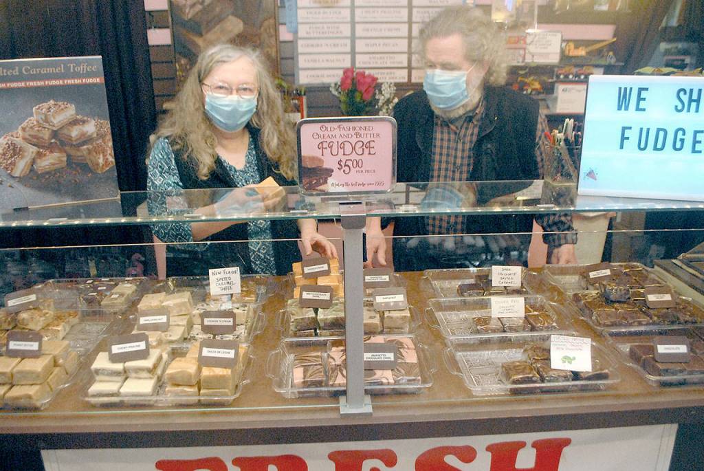 Northwest Fudge and Confections co-owners Lindi and Bob Lumens wear their masks behind the fudge counter in their downtown Port Angeles candy store. Photo by Keith Thorpe/Olympic Peninsula News Group