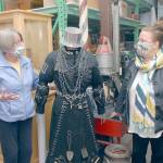 Kathy Estes, retiring executive director of the North Olympic History Center, formerly the Clallam County Historical Society, left, speaks with Amy McIntyre, who will begin work in that position in August. The pair discuss a mannequin adorned in a reproduction of an outfit made for a former downtown Port Angeles hardware store. (Keith Thorpe/Peninsula Daily News)