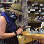 Heather Amoranto of Lakewood smells lavender oils inside Sunshine Herb & Lavender Farms farm store on July 19. She visited last year and wanted to come back for her birthday weekend. Sunshine was one of seven farms she visited that day. Sequim Gazette photo by Matthew Nash