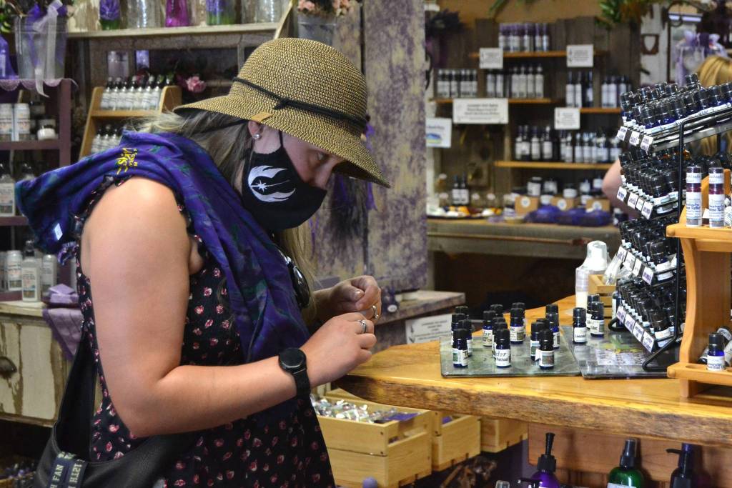 Heather Amoranto of Lakewood smells lavender oils inside Sunshine Herb & Lavender Farms farm store on July 19. She visited last year and wanted to come back for her birthday weekend. Sunshine was one of seven farms she visited that day. Sequim Gazette photo by Matthew Nash
