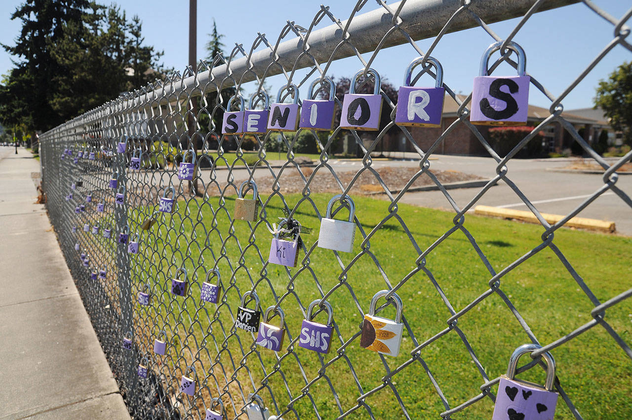 Padlocks celebrating Sequim High Schools Class of 2020 line the chain-link fence near the school on North Sequim Avenue this week. School district officials are contemplating reopening the school campuses for classes in the fall. Sequim Gazette photo by Michael Dashiell