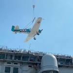 John Johnsons T-6 airplane is loaded on July 25 aboard the USS Essex for its journey to Pearl Harbor for the 75th commemoration of the end of War War II in the Pacific Ocean in late August. Photo courtesy of Dave Richardson