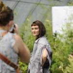 Photographer Cindy Roth snaps shots of Sequim model Aurora Lagattuta for impact Fashions sustainable fashion show on Aug. 6 inside a greenhouse at New Dungeness Nursery. Sequim Gazette photo by Matthew Nash