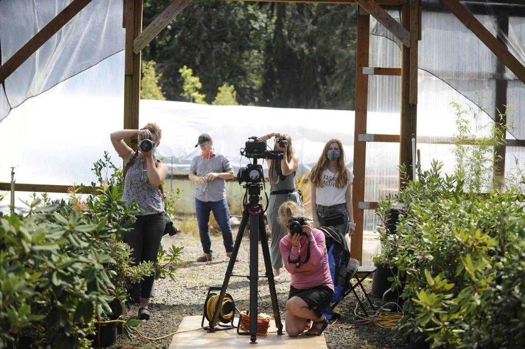 The look down the runway reveals a number of photographers and videographers shooting models for Impact Fashion, a fashion show highlighting designers focused on sustainable clothing and accessories.