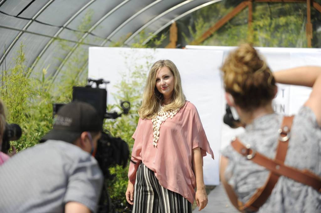 Videographer Silas Crews and photographers Julie Lawrence and Cindy Roth capture Lindsay Sué walk the runway for Impact Fashions show in New Dungeness Nursery. The event will be readied for its debut online Sept. 4 
to promote sustainable fashion. 
Sequim Gazette photo by 
Matthew Nash