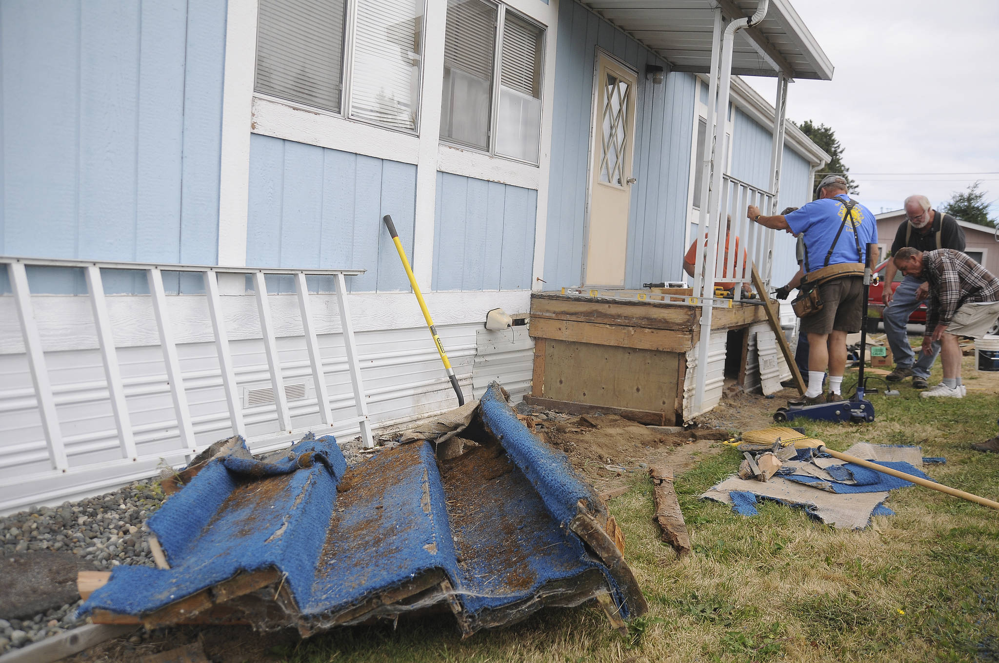 Members of the Sequim Valley Lions Club help fix Lori Bittick-Humbers front porch in Carlsborg on Aug. 10. Sequim Gazette photos by Michael Dashiell