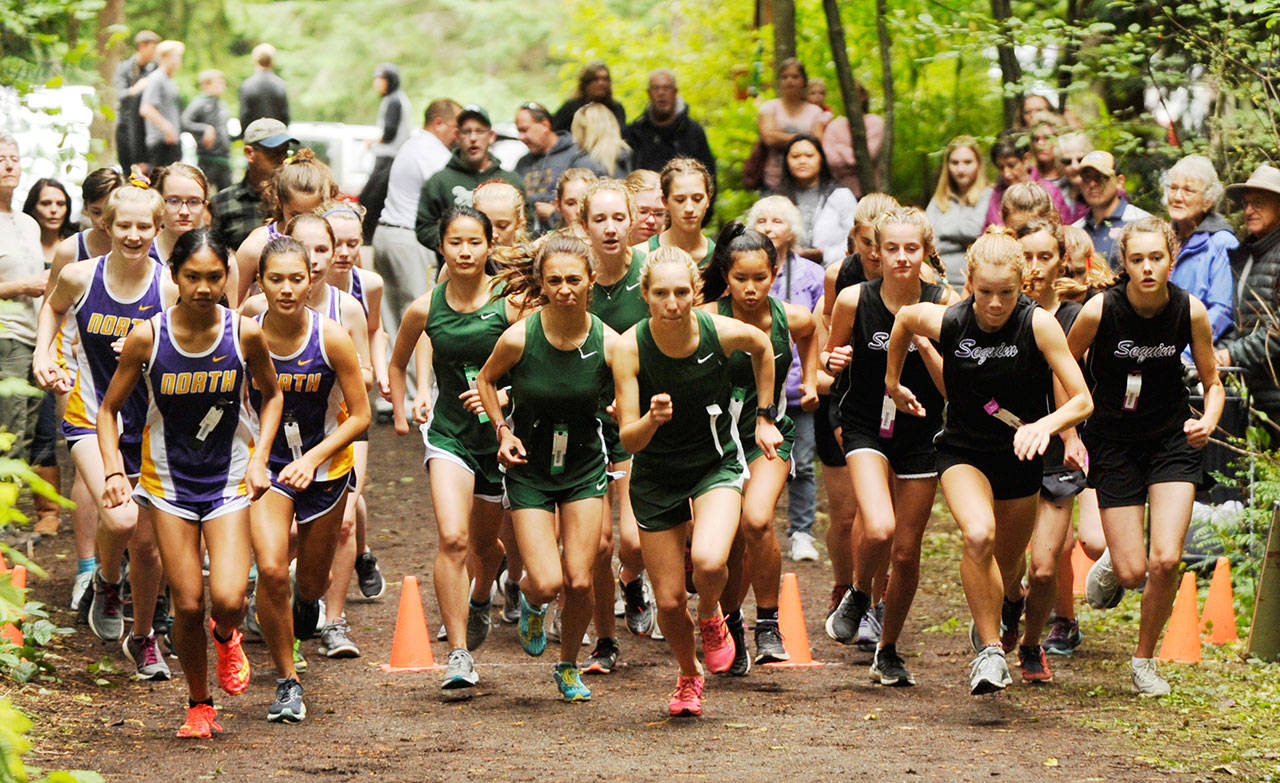Runners from Sequim, Port Angeles and North Kitsap girls cross country squads break from the starting line at Robin Hill County Park at an Olympic League meet in 2019. All of the Olympic Leagues 2020 fall sports  including cross country  have been moved to spring 2021. Sequim Gazette file photo by Michael Dashiell