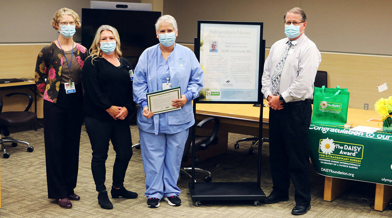 Celebrating Olympic Medical Center nurse Ardith Schuchardt, third from left, for her DAISY Award for Extraordinary Nurses honor are, from left: Sandra McGoldrick, clinical supervisor-obstetrics; Chris Johnson, director of obstetrics and new family services, and OMC chief nursing officer Ralph Parker. Photo courtesy of Olympic Medical Center