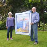 Quiltmaker Dory Miller of Crazy Horse Quilting and 2020 Sequim Bay Yacht Club commodore Jerry Fine display a quilt up for raffle, with proceeds going to Volunteer Hospice of Clallam County. Tickets are $5 each or six for $25. Organizers of the yacht clubs annual Reach and Row for Hospice recently announced the cancellation of the event, and are urging those looking to continue support of the effort to purchase raffle tickets or make a tax-deductible donation. Sequim Gazette photo by Michael Dashiell