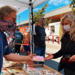 Sequim Farmers & Artisans Market visitors peruse the treats provided by Blue Mountain Baking Co. on Saturday. Photo by Emma Jane Garcia
