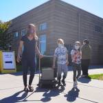Christina Reeves, along with children Jesse, 12, and Alorrah, 8, pick up a computer at Sequim Middle School on Sept. 1. School starts for almost 2,800 Sequim students (estimated) today, Sept. 2, but with COVID-19 restrictions those students are, for the first time, starting the academic remotely. See www.sequimschools.org for more about each schools opening plans, including videos from school administrators. Sequim Gazette photo by Michael Dashiell