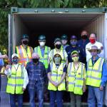 Members of Community Emergency Response Team (CERT) 4 Sunland, board members of Sunland Owners Association (SLOA), and staff for Clallam County Fire District 3 gather for the ceremonial passing of the key from David Walp, SLOA acting president, to Susan Pressman, captain of the Sunland CERT, on Aug. 27. SLOA purchased the trailer and is allowing CERT to use it for emergency preparedness to help Sunlands 900-plus homes in case of disaster. Sequim Gazette photo by Matthew Nash