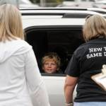 Second-grader Braylon Waters talks with teacher Gretta Rich, left, and Greywolf principal Donna Hudson at the schools packet pick-up on Sept. 2, the first day of school for Sequim students. Sequim Gazette photo by Michael Dashiell