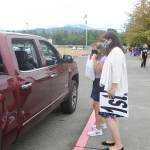 First-grade teachers Gwen Rudzinski, right, and Monique Brasher greet parents and students on Sept. 2, the first day of school for Sequim students, at Greywolf Elementary in Carlsborg. With studentsstarting the academic year learning remotely, teachers and staff handed out instructional materials at the campus. Sequim Gazette photo by Michael Dashiell